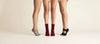 Three models wearing YG Socks premium non-slip five-toe grip socks designed for pilates, yoga, and barre, showcasing different styles including open-back and crew length on a minimalist clean background.