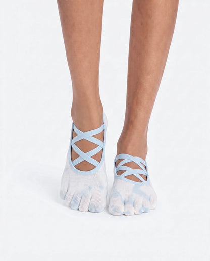 Front view of a person wearing Full Toe Cloud Wash Low Rise Grip Socks, featuring a stylish criss-cross strap design and five-toe separation for natural movement.