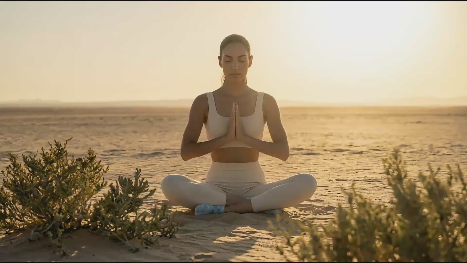 Mindful yoga movement in a vast desert landscape featuring premium tie-dye functional toe socks by YG Socks, demonstrating fluid control and secure traction on the sand.